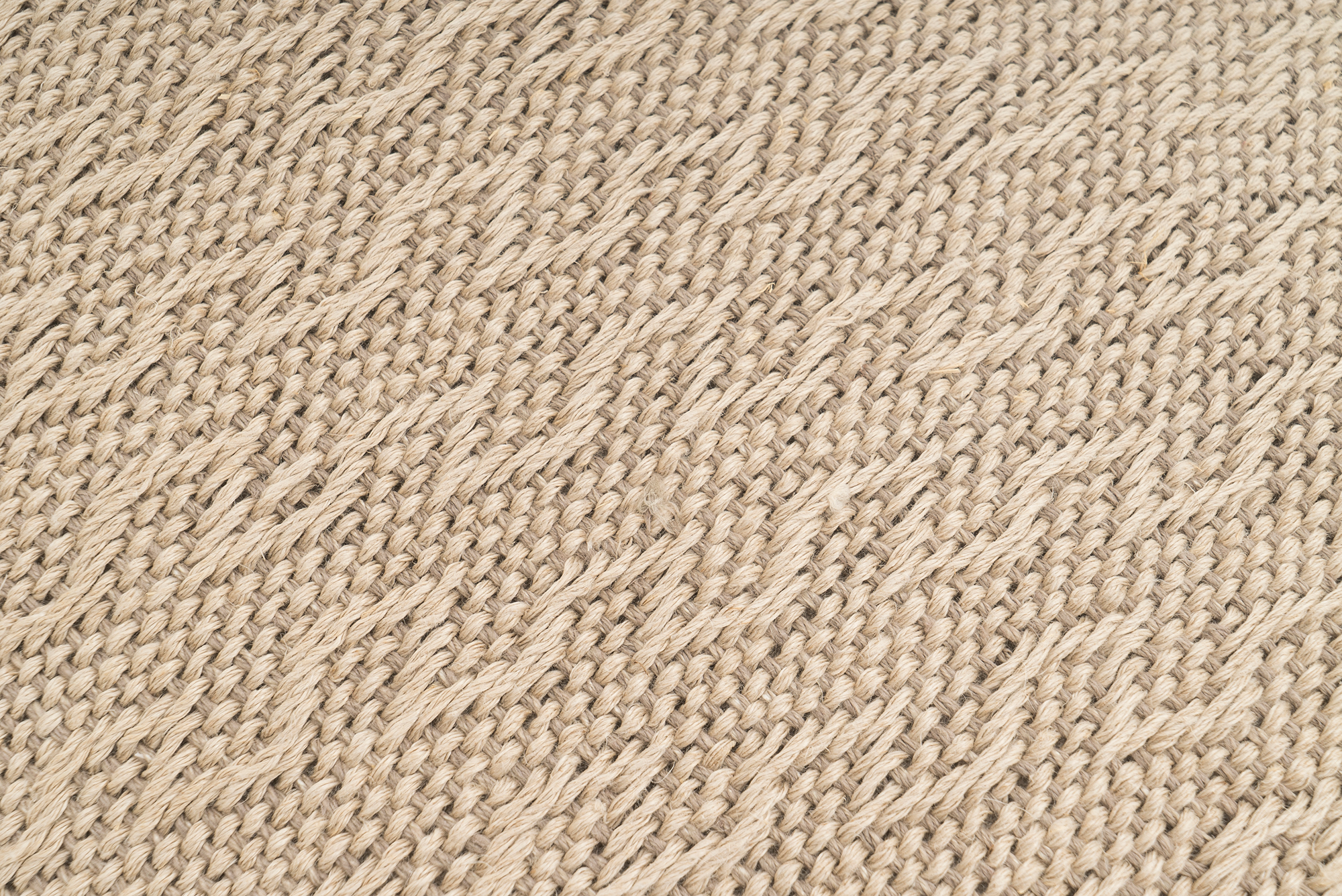 Eco-conscious hemp pillowcase, handwoven with rustic wave pattern, beige hue.