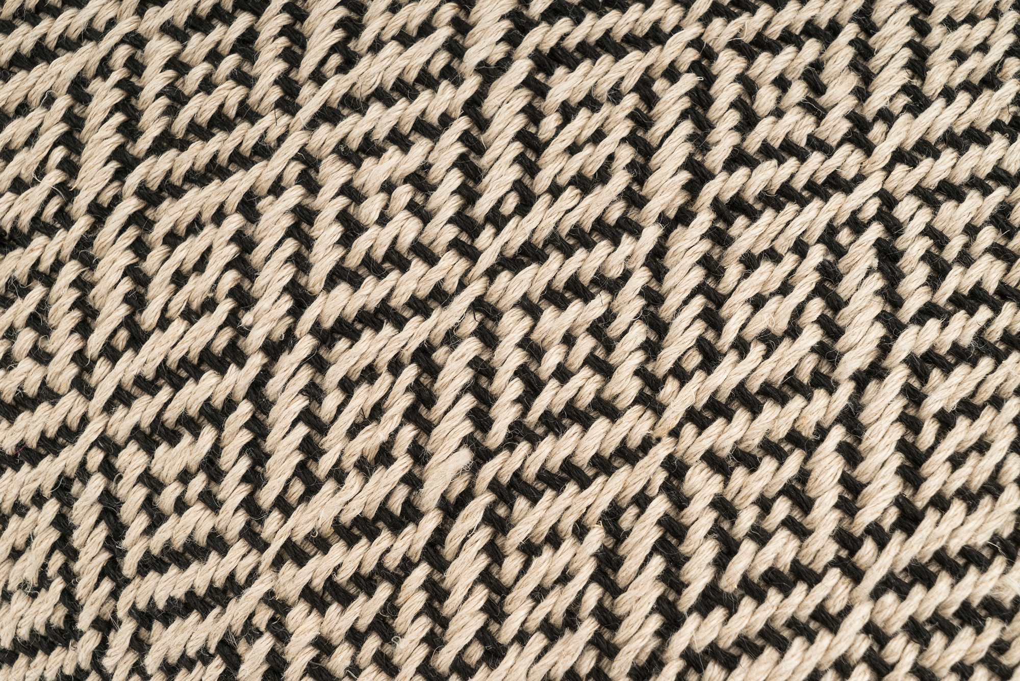 Artisan-crafted hemp pillow cover, beige and black, sustainable and modern decor.