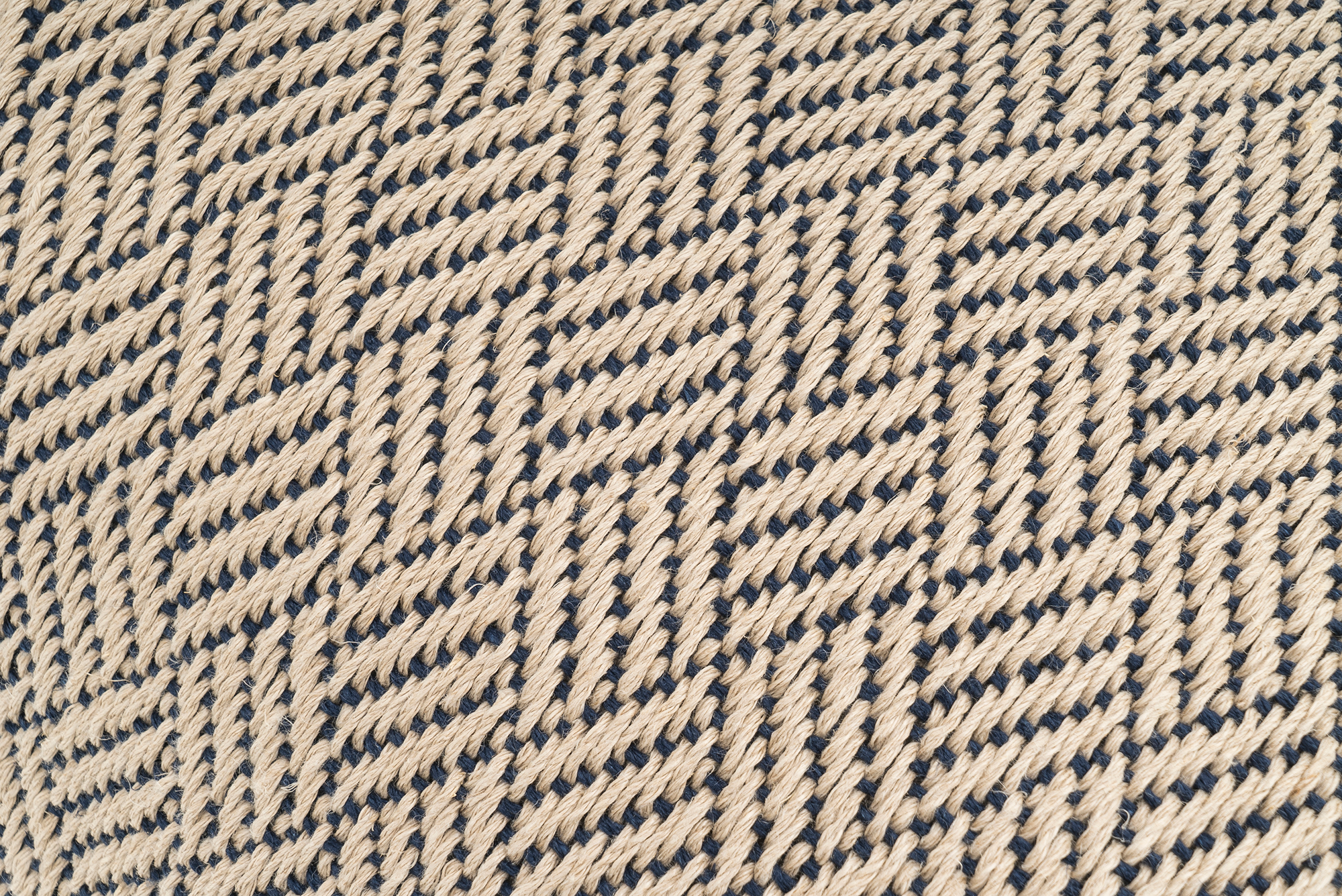 Artisan-crafted hemp pillowcase, featuring a beige and black herringbone pattern, sustainable decor.