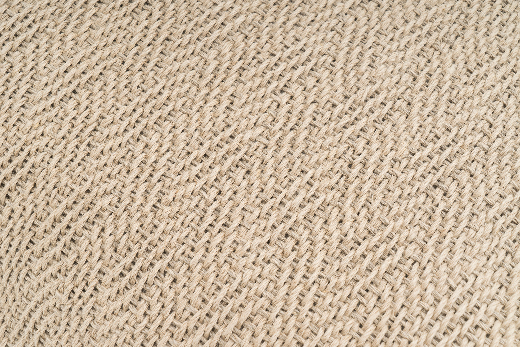 Artisan-crafted hemp pillowcase, featuring a beige herringbone pattern, sustainable decor.