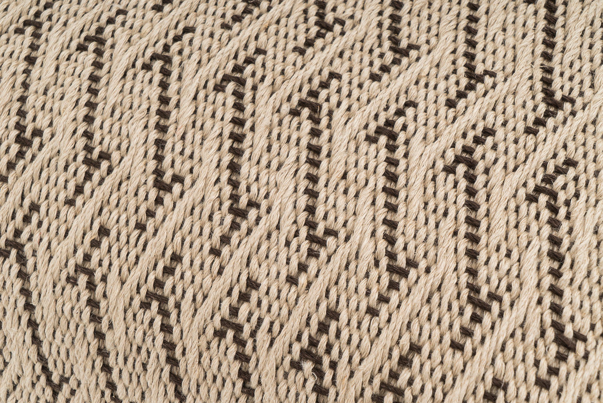 Sustainable hemp pillowcase, handwoven with zigzag design, beige and black tones.